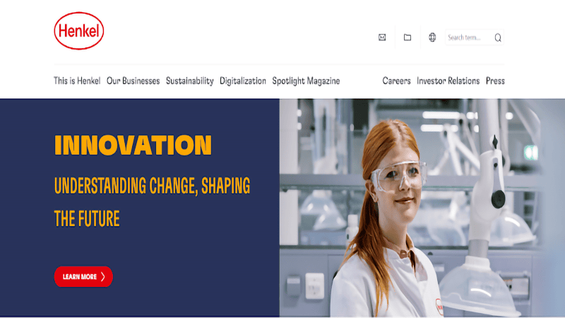 Henkel website header: 'INNOVATION: UNDERSTANDING CHANGE, SHAPING THE FUTURE' displayed on a dark blue section, paired with an image of a lab professional (in a white coat & safety goggles) in a high-tech laboratory; Henkel logo at the top left.