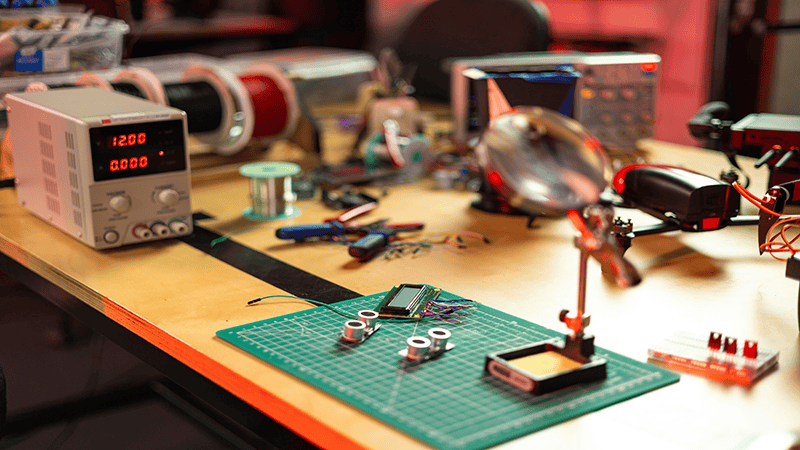 Various electronic components are placed on the workbench.