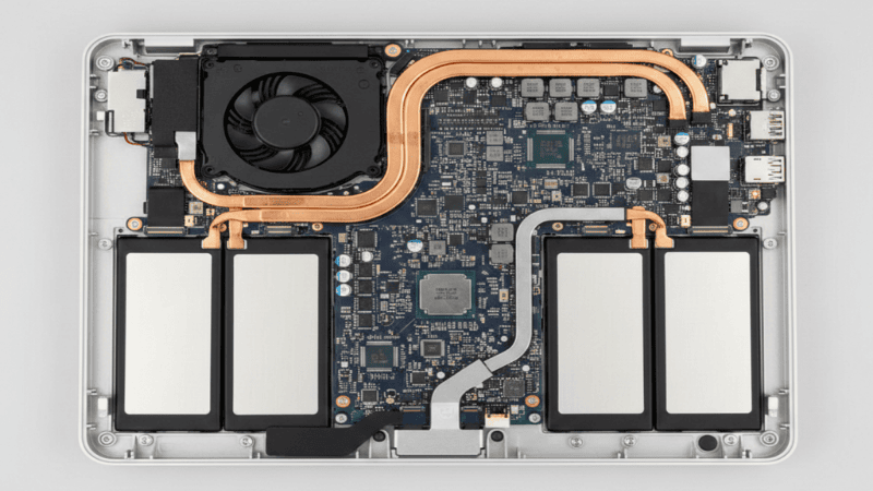 Internal view of MacBook Pro M1 logic board battery and cooling layout before thermal pad modification