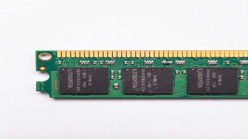 DDR SDRAM memory module (desktop RAM with black chips on green PCB, close-up of edge connector)