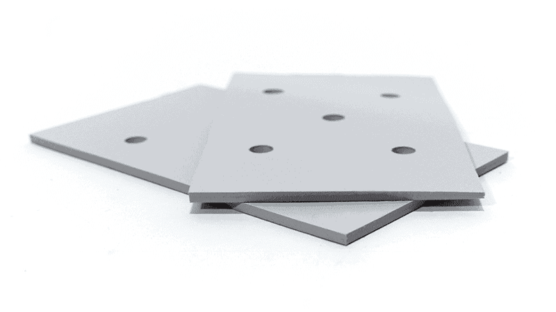 Stacked square gray metal mounting plates (with drilled holes)