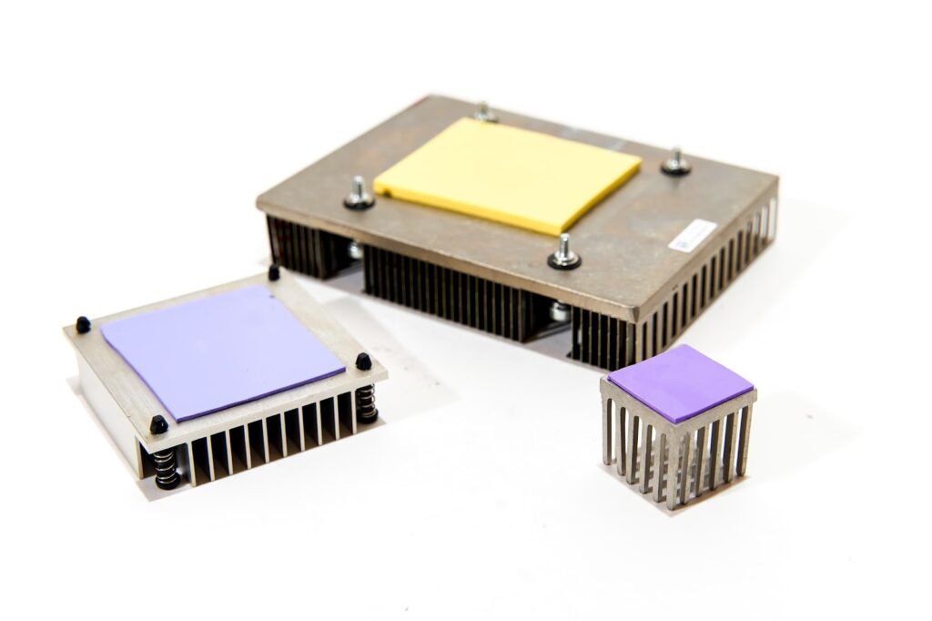 Demonstrates thermal pads mounted on a metal heatsink