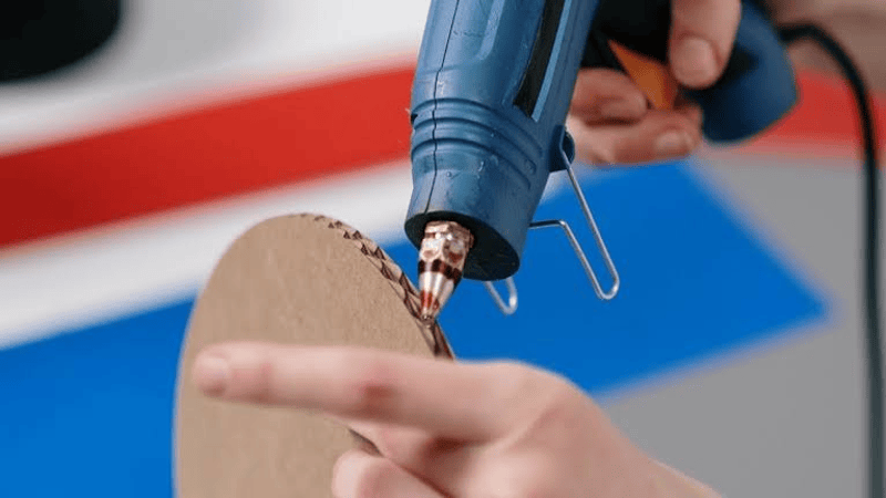 Use a hot glue gun to attach the wrapping paper circle