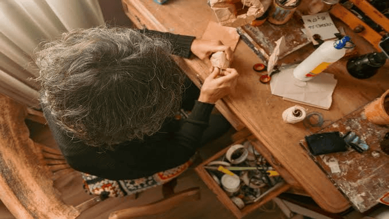 Elderly people use hot melt glue to glue handicrafts